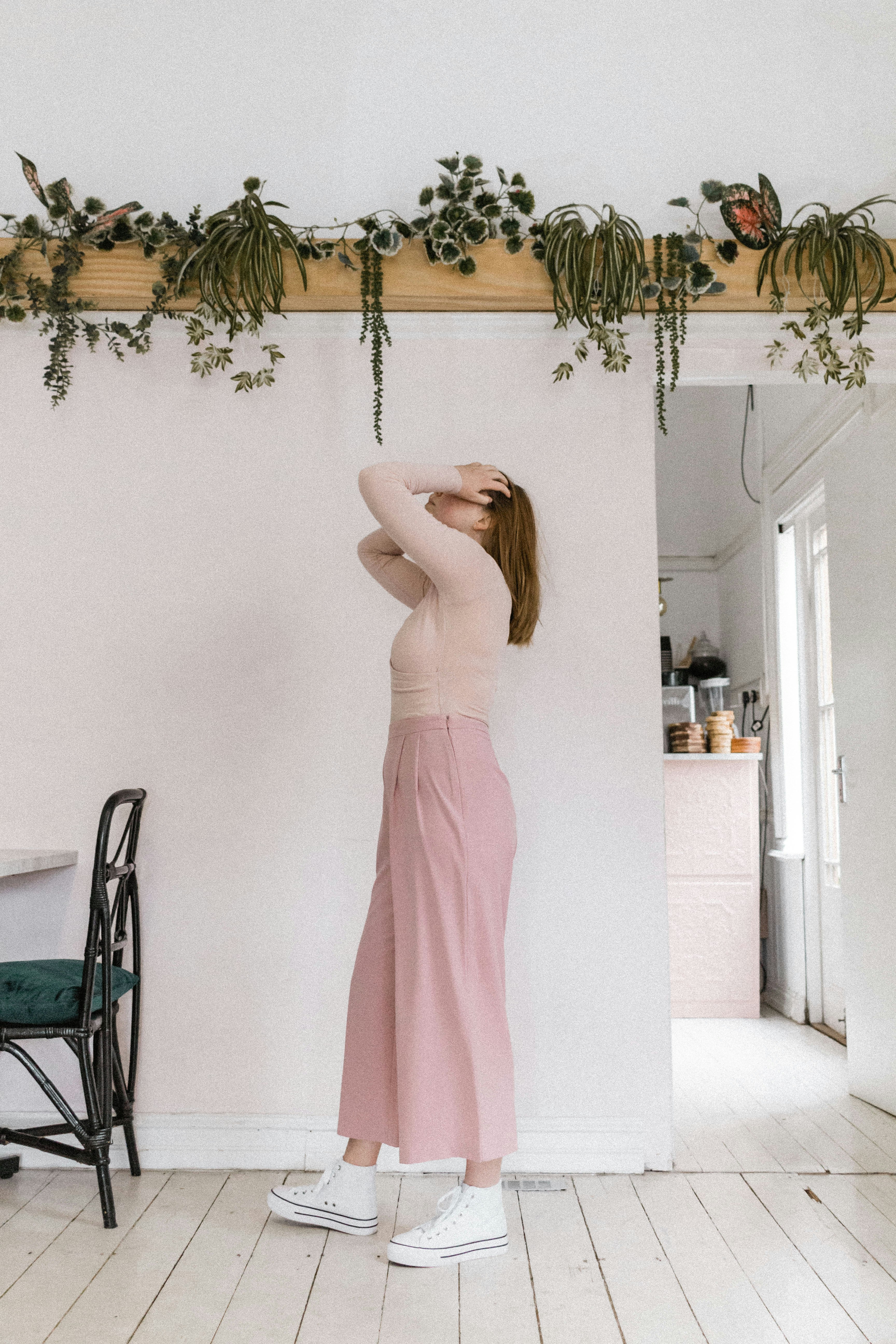 woman in pink tube dress standing near black chair